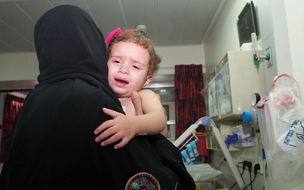 Two-year-old Hala Arada with her grandmother Haniyah Shaer at Wolfson Hospital in Holon, August 12, 2014. Hala has congenital heart disease and is being treated in Israel. Two members of her family were recently killed in an Israeli air strike in Gaza. (photo credit: Sheila Shalhevet/Save a Childs Heart) Two-year-old Hala Arada with her grandmother Haniyah Shaer at Wolfson Hospital in Holon, August 12, 2014. Hala has congenital heart disease and is being treated in Israel. Two members of her family were recently killed in an Israeli air strike in Gaza. (photo credit: Sheila Shalhevet/Save a Childs Heart)