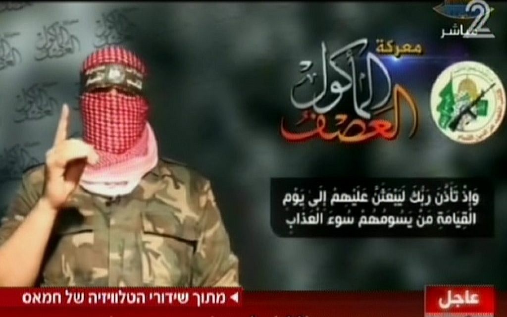 Hamas spokesman Abu Obeida on television Wednesday, August 20, 2014. To the left of the Hamas military-wing logo is text naming the conflict as 'The all-consuming storm.; Below is a passage from the Koran promising divine torture come the Day of Judgement. (Screen capture: Channel 2) Hamas spokesman Abu Obeida on television Wednesday, August 20, 2014. To the left of the Hamas military-wing logo is text naming the conflict as 'The all-consuming storm.; Below is a passage from the Koran promising divine torture come the Day of Judgement. (Screen capture: Channel 2)