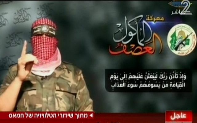Hamas spokesman Abu Obeida on television Wednesday, August 20, 2014. To the left of the Hamas military-wing logo is text naming the conflict as 'The all-consuming storm.; Below is a passage from the Koran promising divine torture come the Day of Judgement. (Screen capture: Channel 2)