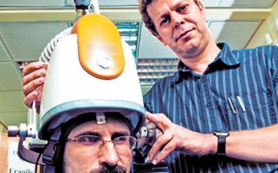 Prof. Abraham Zangen (right) poses with his machine (photo credit: courtesy)