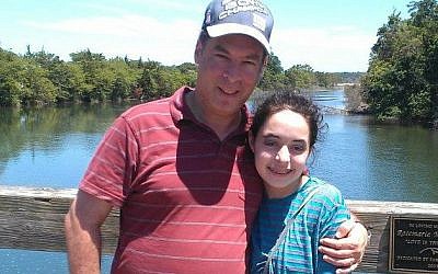 Howard Schoenfeld and his daughter Zahava stumbled upon a mysterious gravestone while strolling on the Long Island beach, July 2014. (Courtesy Howard Schoenfeld/JTA)