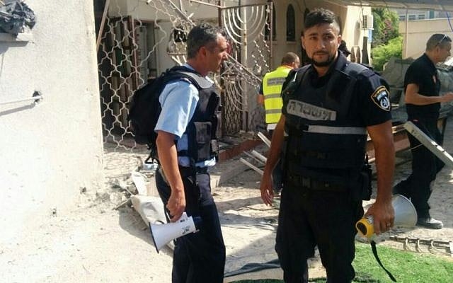 Israel Police forces at the scene of an Ashdod synagogue hit by a rocket from Gaza, August 22, 2014. (Photo credit: Israel Police) Israel Police forces at the scene of an Ashdod synagogue hit by a rocket from Gaza, August 22, 2014. (Photo credit: Israel Police)
