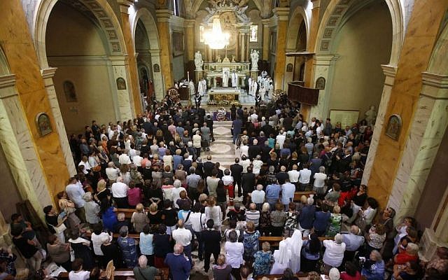 People attend the funeral service of Associated Press video journalist Simone Camilli, at the Pitigliano Cathedral, Italy, Friday, Aug. 15, 2014. (AP Photo/Riccardo De Luca, Pool)