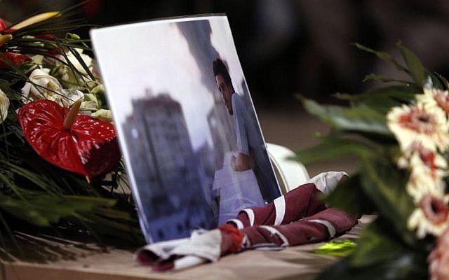 A picture of Associated Press video journalist Simone Camilli lies on his coffin during the funeral service at the Pitigliano Cathedral, Italy, Friday, Aug. 15, 2014. (AP Photo/Riccardo De Luca, Pool)