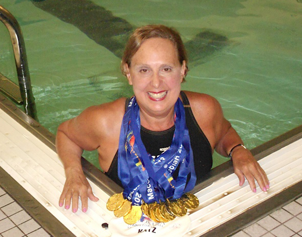 Jane Katz with the 13 medals she won at the 19th Maccabiah Games. (Courtesy)