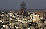 Smoke and debris rise after an Israeli strike hit Gaza City in the northern Gaza Strip, Tuesday, Aug. 19, 2014. (photo credit: AP Photo/Adel Hana)