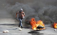Illustrative photo of a Palestinian protester during clashes with Israeli soldiers in the West Bank city of Nablus, August 22, 2014. (photo credit: AP/Nasser Ishtayeh)