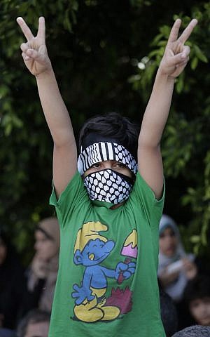 A Palestinian boy flashes the V-sign as he participates in a Hamas rally in Gaza City, Gaza Strip, Thursday, Aug. 7, 2014 (photo credit: AP/Lefteris Pitarakis)