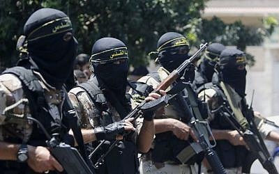 Masked militants of the Islamic Jihad group march during the funeral of their comrade Shaaban Al-Dahdouh, whose body was found under the rubble Tuesday, in Gaza City on Wednesday, Aug. 6, 2014. (Photo credit:AP/Hatem Moussa)