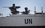 Armored vehicles of UN peacekeepers of UNDOF, the United Nations Disengagement Observer Force, wait to cross from the Israeli-controlled Golan Heights to Syria, on Thursday, August 28, 2014. (photo credit: AP/Ariel Schalit)
