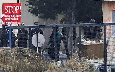 Armed rebels seen at Syria's Quneitra border crossing to the Israeli-controlled Golan Heights, Friday, Aug. 29, 2014. (photo credit: AP Photo/Ariel Schalit)