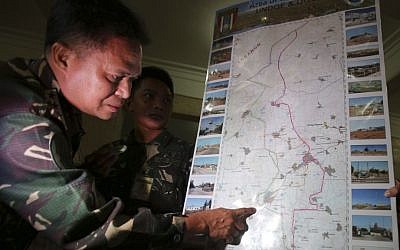 Philippine military chief Gen. Gregorio Pio Catapang shows reporters where Filipino peacekeepers in Golan Heights have been repositioned during a press conference at Camp Aguinaldo military headquarters in suburban Quezon city, Philippines on Sunday Aug. 31, 2014. (photo credit: AP Photo/Aaron Favila)