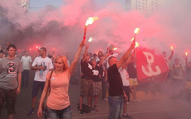 People hold burning flares to commemorate the 70. anniversary of the 1944 Warsaw Uprising in Warsaw, Poland, Friday, Aug. 1, 2014. (AP Photo/Czarek Sokolowski) People hold burning flares to commemorate the 70. anniversary of the 1944 Warsaw Uprising in Warsaw, Poland, Friday, Aug. 1, 2014. (AP Photo/Czarek Sokolowski)