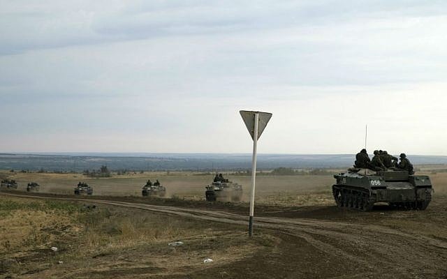 Russian armored personnel carriers move in a field close to the Russia-Ukrainian border near the town of Donetsk, Rostov-on-Don region, Russia, Monday, Aug. 18, 2014. (photo credit: AP/Pavel Golovkin) Russian armored personnel carriers move in a field close to the Russia-Ukrainian border near the town of Donetsk, Rostov-on-Don region, Russia, Monday, Aug. 18, 2014. (photo credit: AP/Pavel Golovkin)
