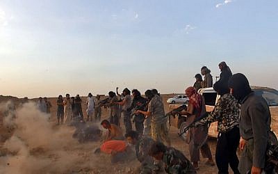 Masked gunmen of the Islamic State shooting seven men kneeling in front of them, in the aftermath of the group's takeover of the Tabqa air base in Raqqa province, Syria. (photo credit: AP/Raqqa Media Center of the Islamic State group)
