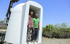 Thai foreign workers standing in a mobile bomb shelter at Moshav Beit HaGadi in the Southern Israel on August 20, 2014. (Edi Israel/Flash90)