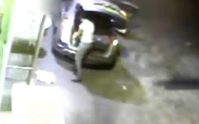 One of the suspects in the murder of Muhammed Abu Khdeir is seen filling bottles with gasoline on the night of the killing (Photo credit: Channel 2 screen capture)