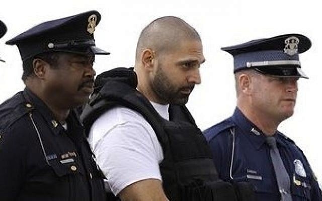 FILE - In this Aug. 26, 2010 file photo, Elias Abuelazam is escorted by authorities after arriving on a flight in Flint, Mich. Abuelazam, serving a life sentence for murder in a series of stabbings in the Flint area is suing to be deported to Israel, his home country. (photo credit: AP Photo/Paul Sancya) FILE - In this Aug. 26, 2010 file photo, Elias Abuelazam is escorted by authorities after arriving on a flight in Flint, Mich. Abuelazam, serving a life sentence for murder in a series of stabbings in the Flint area is suing to be deported to Israel, his home country. (photo credit: AP Photo/Paul Sancya)