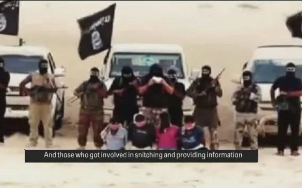 Members of Ansar Bayt al-Maqdis in the Egyptian Sinai read out sentences before they behead four men accused of spying for Israel, August 2014 (screen capture: YouTube)