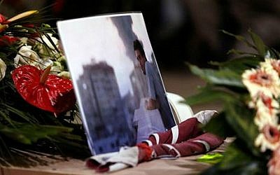 A picture of Associated Press video journalist Simone Camilli, who was killed Wednesday along with a freelance Palestinian translator working with him when ordnance left over from Israeli-Hamas fighting exploded, lies on his coffin during the funeral service at the Pitigliano Cathedral, Italy, Friday, Aug. 15, 2014 (photo credit: AP/Riccardo De Luca, Pool)