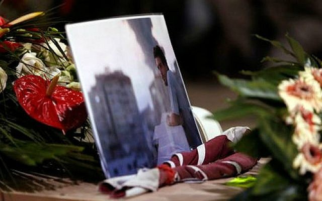 A picture of Associated Press video journalist Simone Camilli, who was killed Wednesday along with a freelance Palestinian translator working with him when ordnance left over from Israeli-Hamas fighting exploded, lies on his coffin during the funeral service at the Pitigliano Cathedral, Italy, Friday, Aug. 15, 2014 (photo credit: AP/Riccardo De Luca, Pool) A picture of Associated Press video journalist Simone Camilli, who was killed Wednesday along with a freelance Palestinian translator working with him when ordnance left over from Israeli-Hamas fighting exploded, lies on his coffin during the funeral service at the Pitigliano Cathedral, Italy, Friday, Aug. 15, 2014 (photo credit: AP/Riccardo De Luca, Pool)