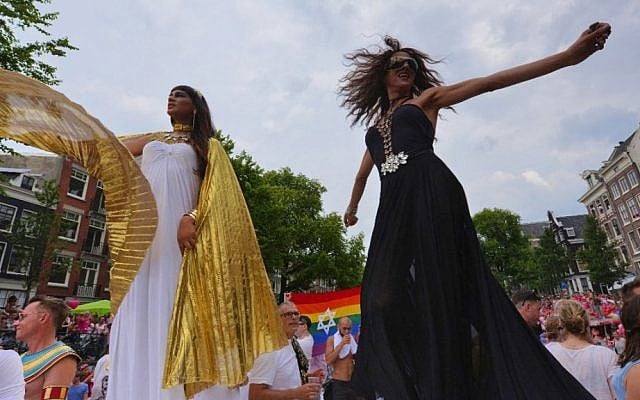 Israeli pop singer Dana International, right, dancing on the Jewish boat at the Amsterdam gay pride parade, Aug. 2, 2014. (Cnaan Liphshiz/JTA)