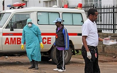 Health workers outside Connaught Hospital after the arrival of a patient with symptoms of the Ebola virus in the city of Freetown, Sierra Leone,  August 4, 2014. (photo credit: AP/Youssouf Bah)