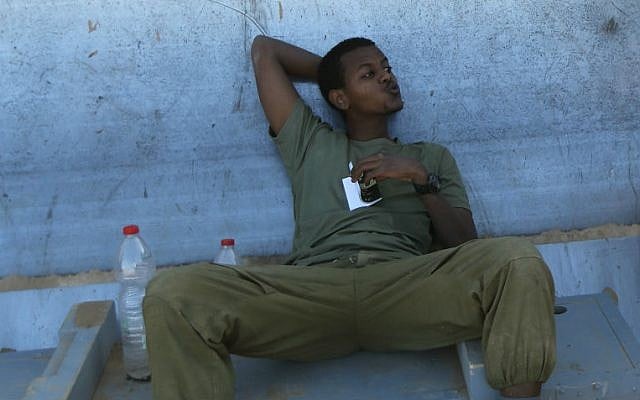 An Israeli soldier at an IDF staging area near the Israeli border with Gaza, on July 31, 2014 (photo credit: Yaakov Naumi/Flash90) An Israeli soldier at an IDF staging area near the Israeli border with Gaza, on July 31, 2014 (photo credit: Yaakov Naumi/Flash90)
