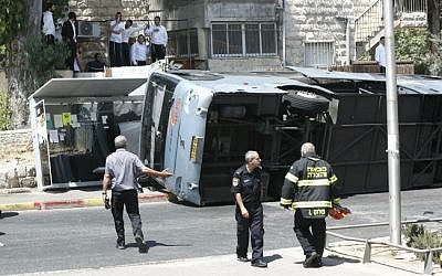 The scene where a tractor driver flipped over a bus on Shmuel Hanavi Street in Jerusalem, on Monday, August 4, 2014. (photo credit: Yonatan Sindel/Flash90)