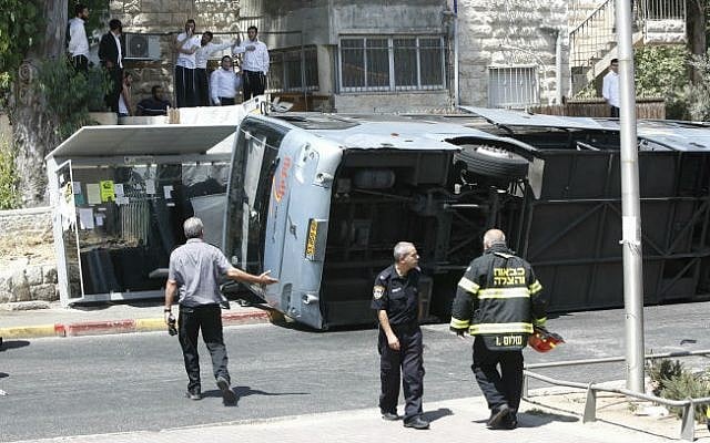 The scene where a tractor driver flipped over a bus on Shmuel Hanavi Street in Jerusalem, on Monday, August 4, 2014. (photo credit: Yonatan Sindel/Flash90) The scene where a tractor driver flipped over a bus on Shmuel Hanavi Street in Jerusalem, on Monday, August 4, 2014. (photo credit: Yonatan Sindel/Flash90)