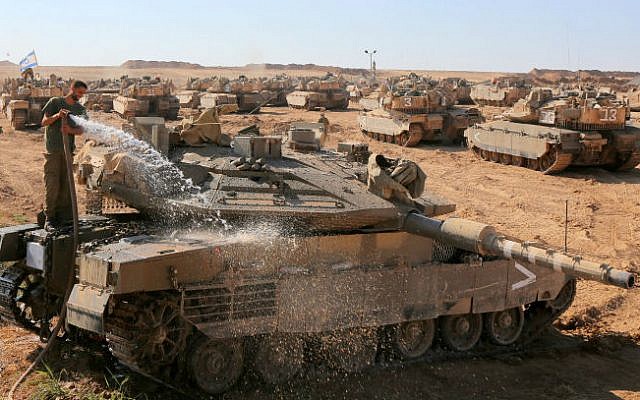 An Israeli soldier cleans a tank at a staging area in Southern israel, as Hamas terrorists in Gaza continue to fire rockets into Israel on the 34rd day of Operation Protective Edge, August 10. 2014. (photo credit: Edi Israel/Flash90) An Israeli soldier cleans a tank at a staging area in Southern israel, as Hamas terrorists in Gaza continue to fire rockets into Israel on the 34rd day of Operation Protective Edge, August 10. 2014. (photo credit: Edi Israel/Flash90)