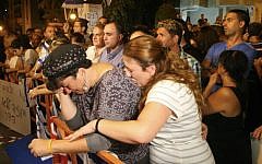 Israelis gather outside the Goldin home in the central Israeli city of Kfar Saba on August 2, 2014 to show support for the family of Lt. Hadar Goldin, who was killed in Gaza on Friday morning, August 1 (photo credit: Flash90)
