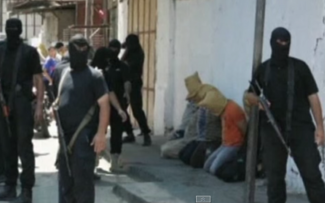 Hamas gunmen in Gaza with suspected collaborators in August 2014. (screen capture: YouTube/euronews) Hamas gunmen in Gaza with suspected collaborators in August 2014. (screen capture: YouTube/euronews)