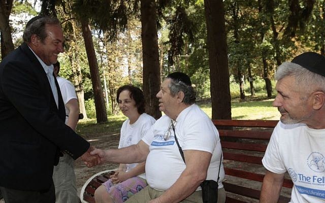 Rabbi Yechiel Eckstein greets refugees from eastern Ukraine at the International Fellowship of Christians and Jews-sponsored camp that is providing a safe have for these displaced persons. (courtesy) Rabbi Yechiel Eckstein greets refugees from eastern Ukraine at the International Fellowship of Christians and Jews-sponsored camp that is providing a safe have for these displaced persons. (Olivia Pitoussi)