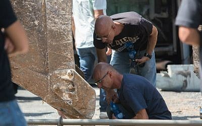 Security personnel inspect the scene where an excavator driver from the Est Jerusalem neighborhood of Jabel Mukaber overturned a bus on Shmuel HaNavi street in Jerusalem on Monday, August 4, 2014 (photo credit: Yonatan Sindel/Flash90)