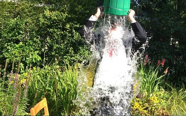 Yesh Atid MK Dov Lipman pours a bucket of ice-cold water on his head, taking the Ice Bucket Challenge for the cause of fighting ALS. (photo credit: Benji Goldberg)