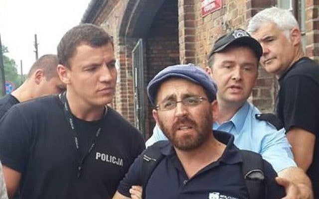 Rabbi Rafi Ostroff detained by security guards at Auschwitz-Birkenau, August 1, 2014. (Photo credit: Rafi Ostroff's Facebook page) Rabbi Rafi Ostroff detained by security guards at Auschwitz-Birkenau, August 1, 2014. (Photo credit: Rafi Ostroff's Facebook page)