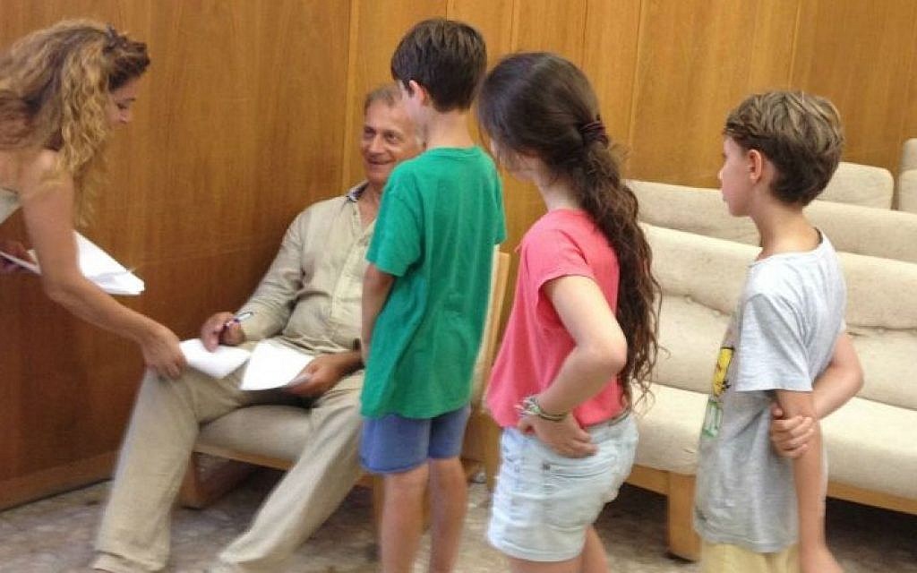 Fans line up for autographs from Matti Caspi, the iconic musician and singer who showed up at Kibbutz Be'eri for an impromptu concert on July 31, 2014. (Jessica Steinberg/Times of Israel) Fans line up for autographs from Matti Caspi, the iconic musician and singer who showed up at Kibbutz Be'eri for an impromptu concert on July 31, 2014. (Jessica Steinberg/Times of Israel)