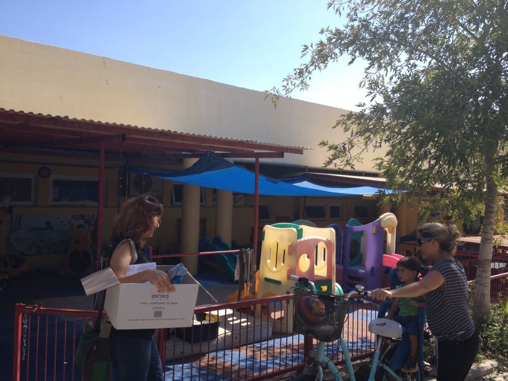 Even the daycare center and kindergarten is in flux at Be'eri, as some of the regular caregivers escaped up north with their families, leaving unfamiliar faces with the babies and toddlers (photo credit: Jessica Steinberg/Times of Israel)