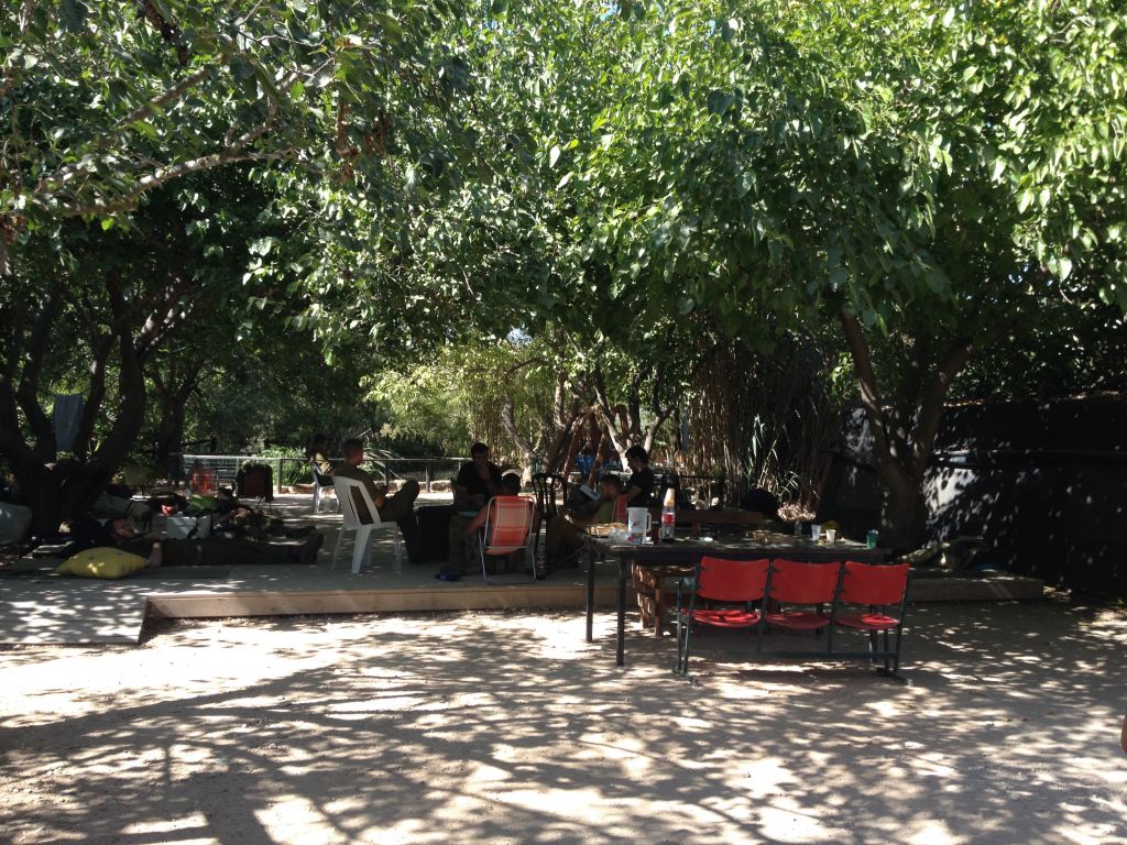 Soldiers are everywhere on Be'eri, in the dining hall, sleeping in the gym, showering in people's homes and finding some shade and quiet wherever they can (photo credit: Jessica Steinberg/Times of Israel)