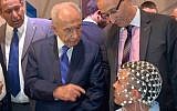 Former president Shimon Peres checks out ElMindA's technology at the 2013 Presidential Conference in Jerusalem. (photo credit: Courtesy ElMindA)