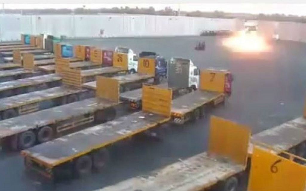 A rocket explodes in the Kerem Shalom border crossing compound, hindering the flow of goods into Gaza, on August 10, 2014. (screen capture: YouTube/zafat 1986)