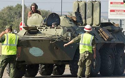 Military road police direct one of several military vehicles of Russian peacekeeping forces to turn to customs control zone about 28 kilometers from Ukrainian border, Rostov-on-Don region, Russia, Friday, Aug. 15, 2014 (photo credit: AP/Pavel Golovkin)