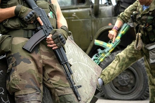 Pro-Russian rebels hold their guns as they patrol the Lenin square in the town of Donetsk, eastern Ukraine, on Thursday, August 28, 2014. (photo credit: AP/Mstislav Chernov) 