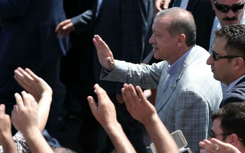 Then-Turkish Prime Minister Recep Tayyip Erdogan salutes cheering supporters at a polling station during the presidential elections in Istanbul, Turkey, Sunday, Aug. 10, 2014. (photo credit: AP/Emrah Gurel)