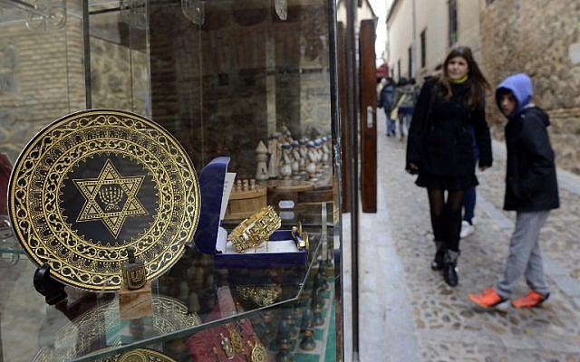 Illustrative: People stand near a gift shop in the old Jewish Quarter of Toledo, Spain on February 27, 2014. (photo credit: AFP/Gerard Julien) Illustrative: People stand near a gift shop in the old Jewish Quarter of Toledo, Spain on February 27, 2014. (photo credit: AFP/Gerard Julien)