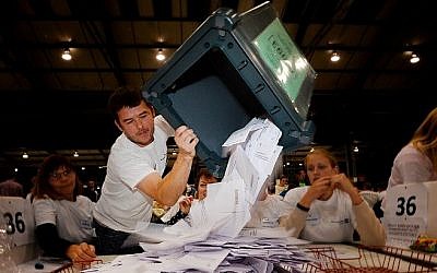 A worker tips out a ballot box in the Aberdeen Exhibition and Conference Centre in Aberdeen, on September 18, 2014, immediately after the polls close in the referendum on Scotland's independence. (photo credit: Ben Stansall/AFP) A worker tips out a ballot box in the Aberdeen Exhibition and Conference Centre in Aberdeen, on September 18, 2014, immediately after the polls close in the referendum on Scotland's independence. (photo credit: Ben Stansall/AFP)