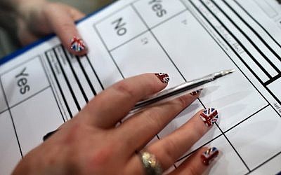 A count observer with Union Jack-painted fingernails looks on as ballot papers are counted in the Aberdeen Exhibition and Conference Centre in Aberdeen, on September 18, 2014, immediately after the polls close in the referendum on Scotland's independence. (photo credit: Ben Stansall/AFP) A count observer with Union Jack-painted fingernails looks on as ballot papers are counted in the Aberdeen Exhibition and Conference Centre in Aberdeen, on September 18, 2014, immediately after the polls close in the referendum on Scotland's independence. (photo credit: Ben Stansall/AFP)