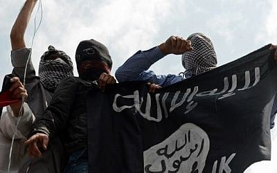 Illustrative photo of men holding up an Islamic State flag. (AFP/Tauseef Mustafa)