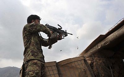 Afghan security personnel fire at Taliban insurgents during an anti-Taliban operation in Dur Baba district near the Pakistan-Afghanistan border in the eastern Nangarhar province on September 25, 2014 (Photo credit: Noorullah Shirzada/AFP)